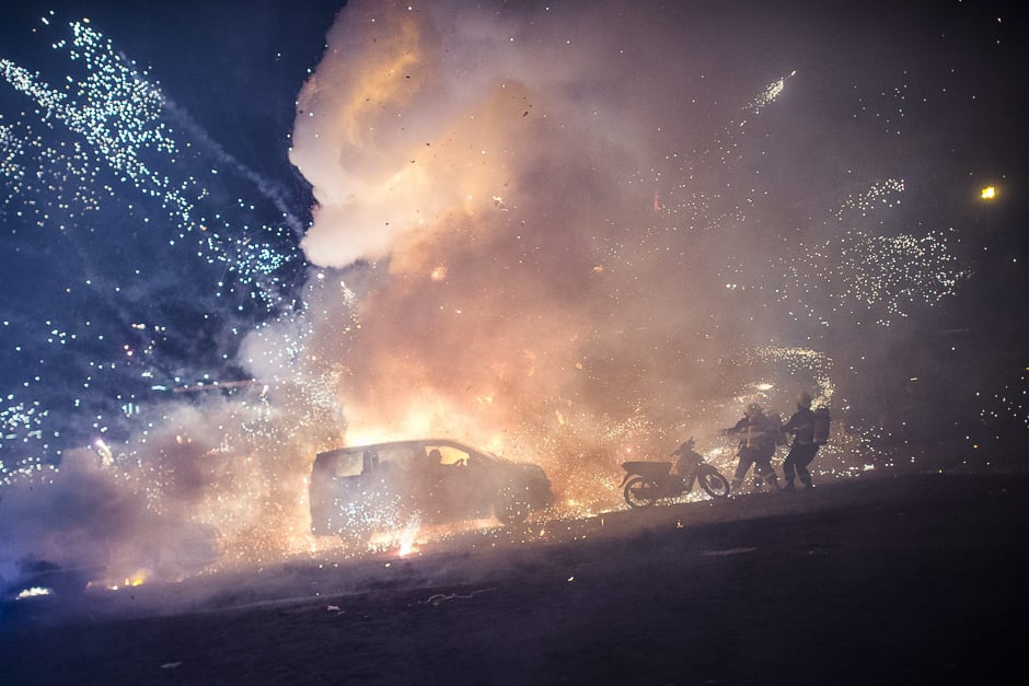 firefighters work after a fireworks laden hot air balloon ignited near a car before the balloon had reached a sufficient height during the closing ceremony of the tazaungdaing festival at taunggyi in myanmar 039 s northeastern shan state photo afp