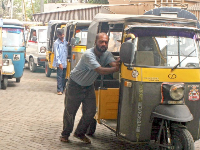 a rickshaw driver in karachi awaits his turn at a cng station in karachi photo athar khan express a rickshaw driver in karachi awaits his turn at a cng station in karachi photo athar khan express