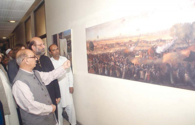 adviser to pm irfan siddiqui takes interest in a painting by jimmy engineer photo inp adviser to pm irfan siddiqui takes interest in a painting by jimmy engineer photo inp