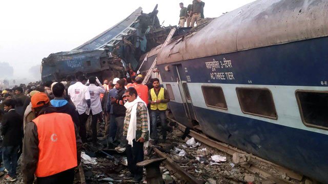 indian rescue workers search for survivors in the wreckage of a train that derailed near pukhrayan in kanpur district on november 20 2016 photo afp