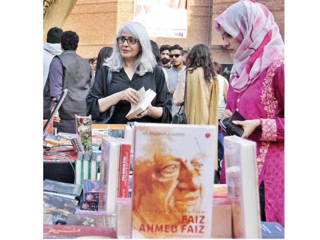 visitors skim through books on sale during the faiz festival at alhamra in lahore photo online visitors skim through books on sale during the faiz festival at alhamra in lahore photo online