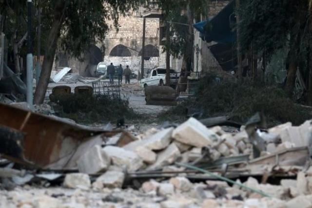 people walk near rubble of damaged buildings in the rebel held besieged area of aleppo syria november 19 2016 photo reuters