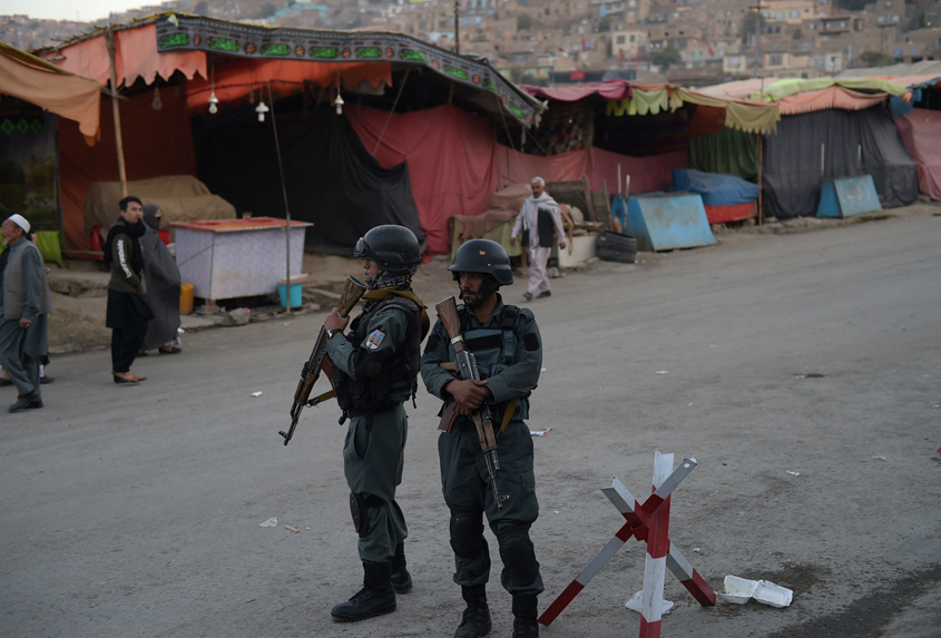 afghan policemen stand guard at the main gate of the karte sakhi shrine in kabul on october 12 2016 photo afp