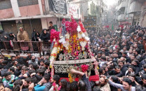 mourners carry a tazia during the main chehlum procession on monday photo abid nawaz express