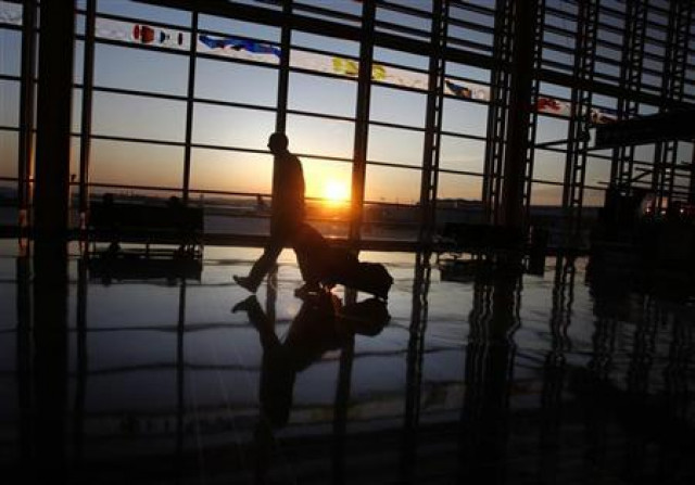 a traveller walks to his flight at ronald reagan national airport as the sun rises in washington september 24 2008 reuters jason reed a traveller walks to his flight at ronald reagan national airport as the sun rises in washington september 24 2008 reuters jason reed