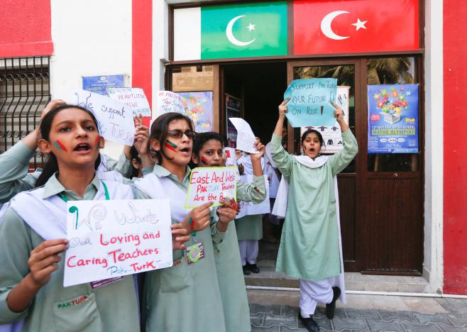 students hold signs as they chant slogans during a protest on the premises of pakturk international schools amp colleges in karachi pakistan november 17 2016 photo reuters