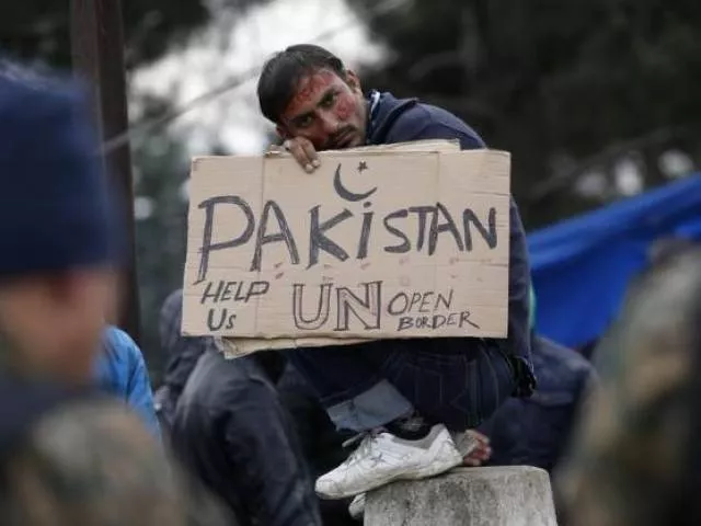 a migrant from pakistan holds a placard while waiting to cross the border from greece into macedonia near gevgelija macedonia november 26 2015 photo reuters a migrant from pakistan holds a placard while waiting to cross the border from greece into macedonia near gevgelija macedonia november 26 2015 photo reuters