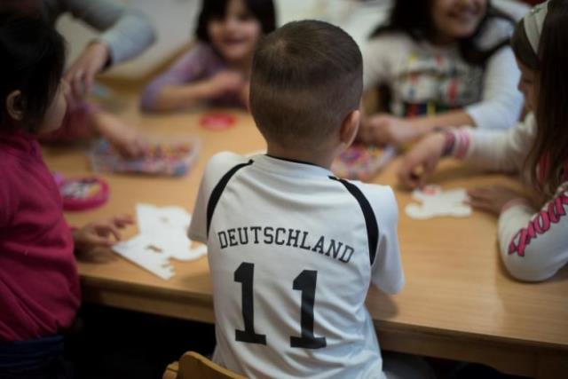 a migrant boy with a shirt that reads 039 039 germany 039 039 plays with others in a childrens room at a refugee shelter which focuses on women and families in berlin germany march 3 2016 photo reuters