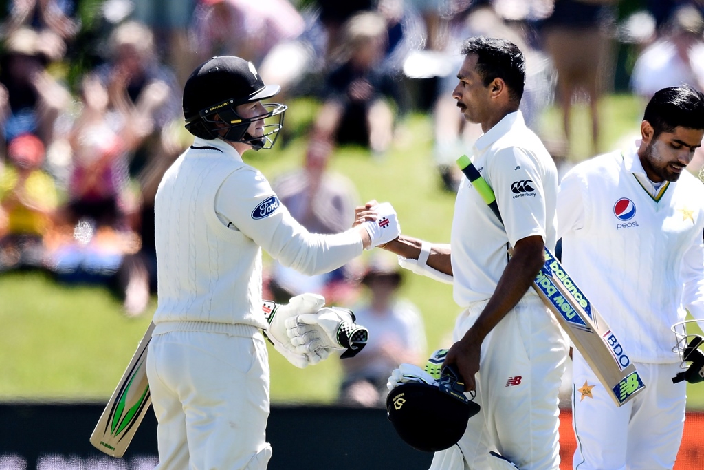 henry nicholls l celebrates with jeet raval after new zealand won the first test at hagley park in christchurch on november 20 2016 photo afp marty melville