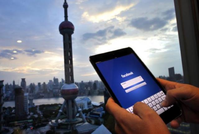 in this photo illustration a man holds an ipad with a facebook application in an office building at the pudong financial district in shanghai september 25 2013 photo reuters