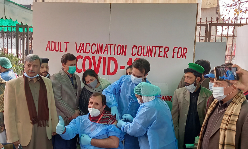 A dose of the Covid-19 vaccine is administered to a health worker in Peshawar. Photo: Sirajuddin