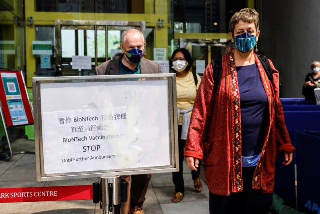 people leave a vaccination centre after hong kong temporarily suspended coronavirus disease covid 19 vaccine from a single batch of pfizer biontech shots due to packaging defects in hong kong china march 24 2021 photo reuters people leave a vaccination centre after hong kong temporarily suspended coronavirus disease covid 19 vaccine from a single batch of pfizer biontech shots due to packaging defects in hong kong china march 24 2021 photo reuters
