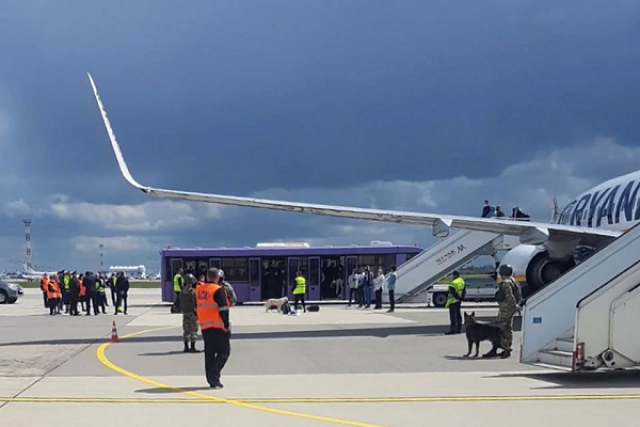 airport personnel and security forces are seen on the tarmac in front of a ryanair flight which was forced to land in minsk belarus may 23 2021 photo reuters airport personnel and security forces are seen on the tarmac in front of a ryanair flight which was forced to land in minsk belarus may 23 2021 photo reuters