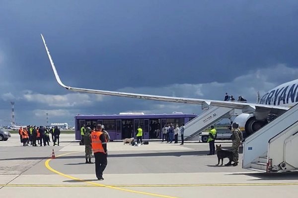 airport personnel and security forces are seen on the tarmac in front of a ryanair flight which was forced to land in minsk belarus may 23 2021 photo reuters