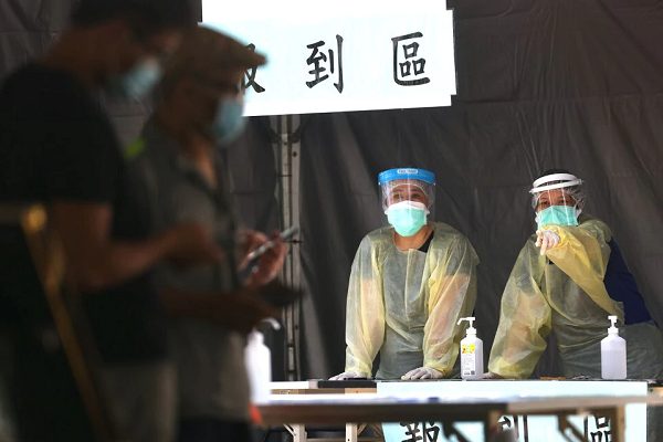 medical workers look on at the check in for people that come to do a rapid test for coronavirus disease covid 19 at a testing site following an increasing number of locally transmitted cases in taipei taiwan photo reuters