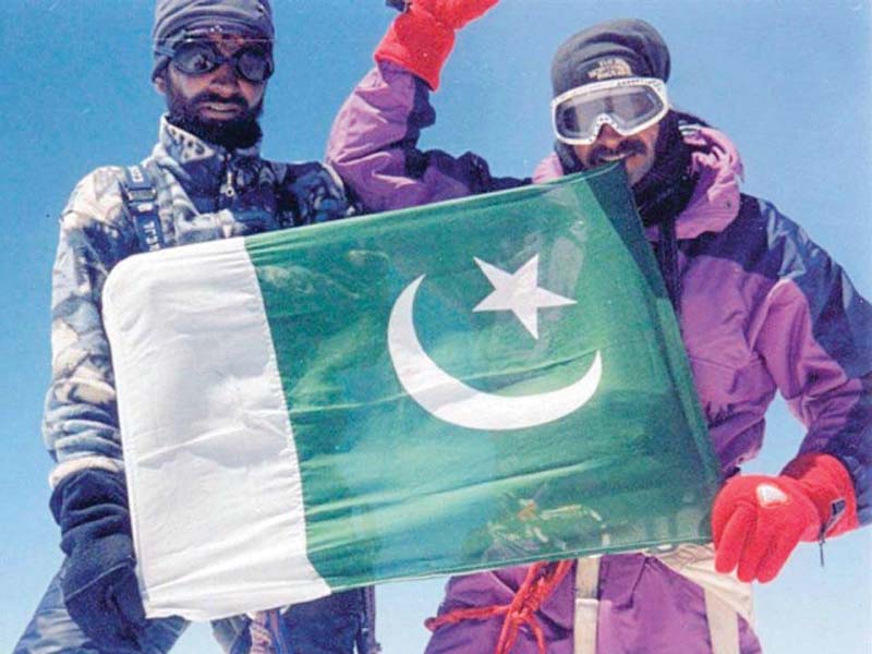 sadpara and fellow climber raising the flag photo file