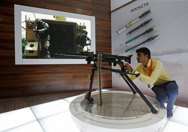 a visitor handles a gun during the exhibition photo reuters a visitor handles a gun during the exhibition photo reuters
