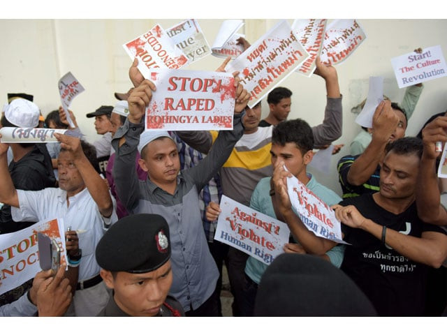 muslims protesters hold messages in the air in front of thai police officials during a protest out side the myanmar embassy in bangkok on november 25 2016 photo afp muslims protesters hold messages in the air in front of thai police officials during a protest out side the myanmar embassy in bangkok on november 25 2016 photo afp