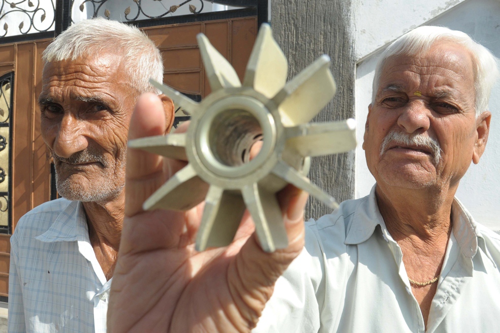 indian villagers display a mortar shell following cross border firing at the india pakistan border in the village arnia about 30 kms from jammu on october 10 2014 photo afp