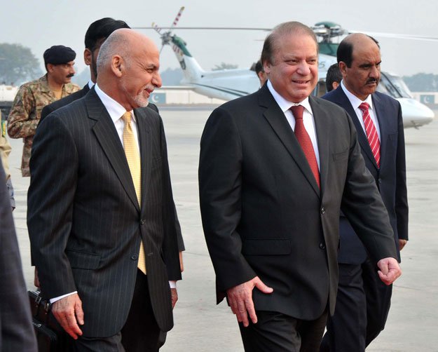 prime minister nawaz sharif walks with afghan president ashraf ghani upon his arrival at the nur khan airbase in rawalpindi on december 9 2015 photo afp