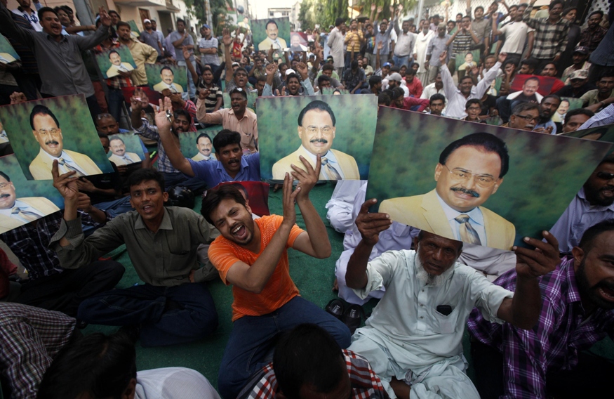 supporters of mqm hold photographs of altaf hussain as they chant slogans during a gathering nine zero in karachi on june 3 2014 following the arrest of hussain in london photo reuters