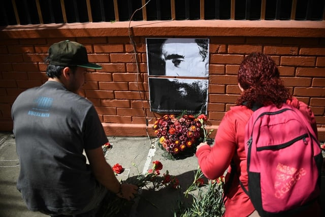 a portrait of cuban historic revolutioonary leader fidel castro is surrounded by flowers as people gather outside the cuban embassy in guatemala city on november 26 2016 photo afp a portrait of cuban historic revolutioonary leader fidel castro is surrounded by flowers as people gather outside the cuban embassy in guatemala city on november 26 2016 photo afp