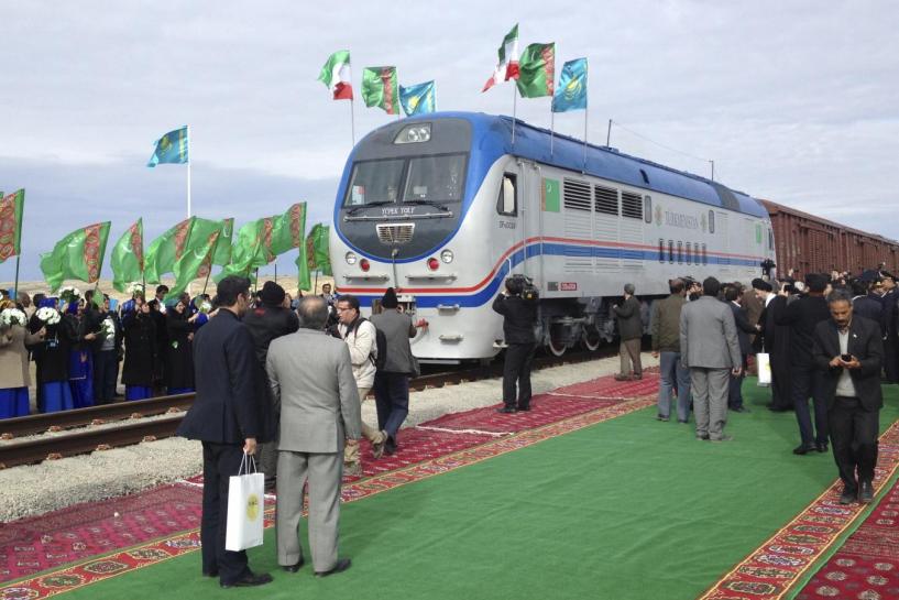 people stand near a freight train during the opening ceremony of the new railway in the turkmenian village of ak yayla december 3 2014 reuters marat gurt