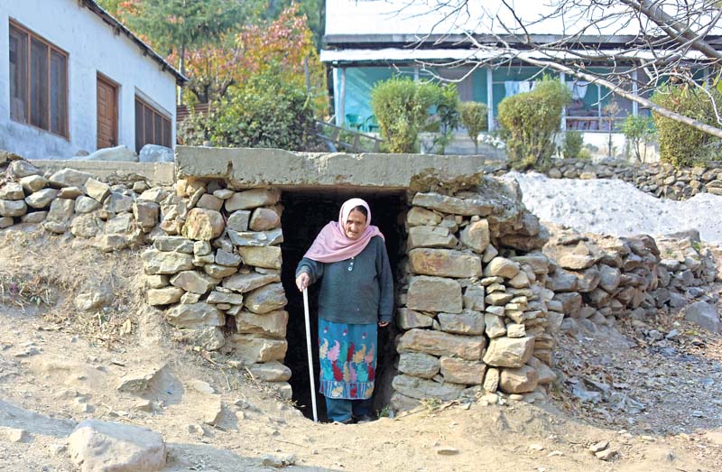 a kashmiri woman walks out of an underground bunker in neelum valley photo afp