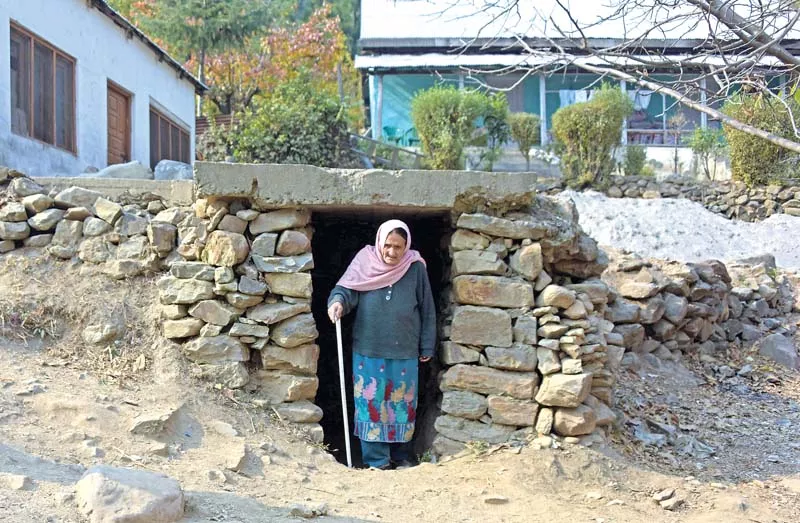 a kashmiri woman walks out of an underground bunker in neelum valley photo afp a kashmiri woman walks out of an underground bunker in neelum valley photo afp