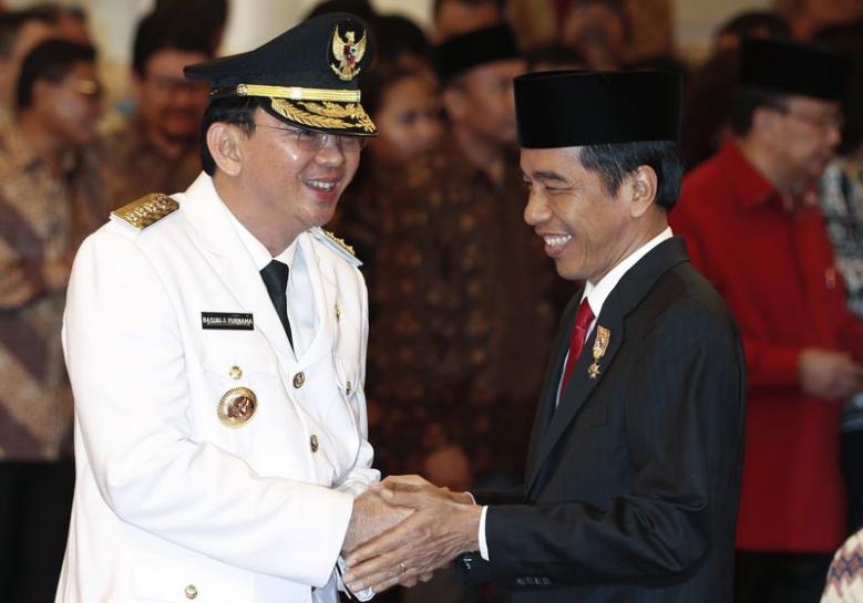 jakarta governor basuki tjahaja purnama l is greeted by indonesia 039 s president joko widodo after his swearing in at the presidential palace in jakarta november 19 2014 reuters beawiharta