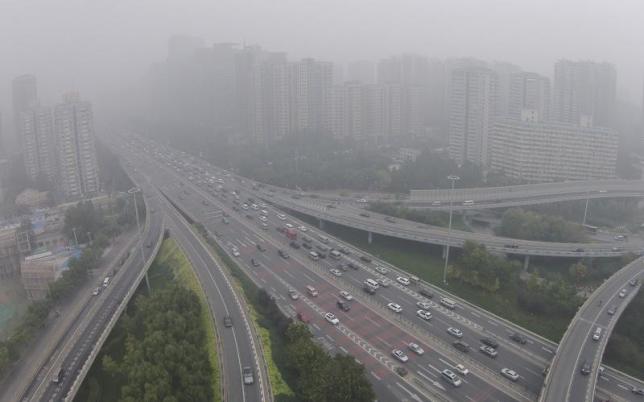 vehicles drive along the residential buildings on beijing 039 s fourth ring road october 11 2014 reuters jason lee