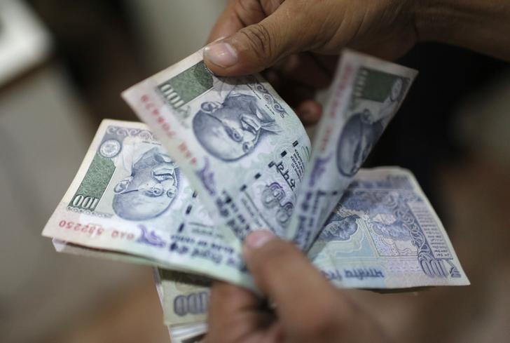 an employee counts rupee notes inside a private money exchange office in new delhi july 5 2013 reuters adnan abidi files