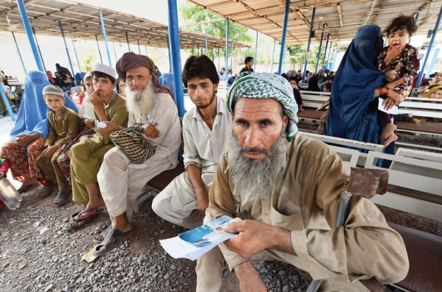 afghan refugees wait to register at the united nations high commissioner for refugees repatriation centre on the outskirts of peshawar photo file afghan refugees wait to register at the united nations high commissioner for refugees repatriation centre on the outskirts of peshawar photo file