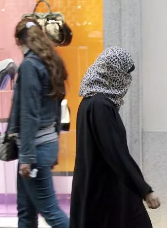 a muslim woman passes a shop with her face covered according to clinton more than a billion people live under governments that suppress religious freedom photo reuters file a muslim woman passes a shop with her face covered according to clinton more than a billion people live under governments that suppress religious freedom photo reuters file