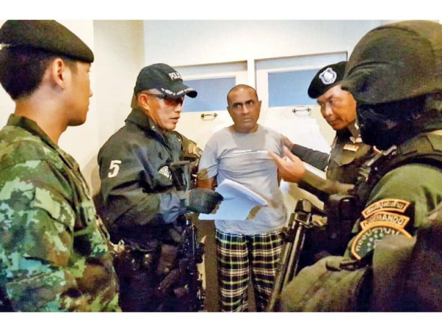 thai police officials detain abdul rehman at the lumpini police station photo afp thai police officials detain abdul rehman at the lumpini police station photo afp