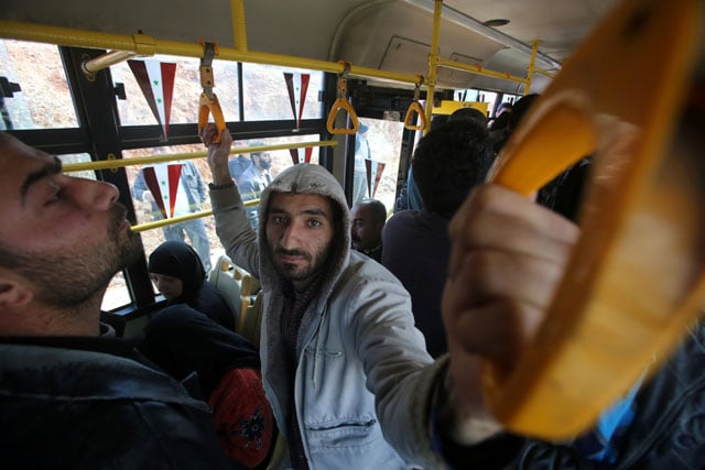 syrians from various western districts wait on a bus at the razi bus stop in aleppo 039 s central jamiliyeh neighbourhood before the start of a bus trip through government held territory between the two sides of the divided city on december 3 2016 as the pro government forces seized 60 percent of the former rebel stronghold in east aleppo photo afp