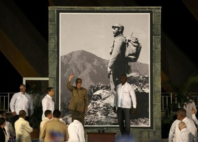 cuban president raul castro waves at a tribute to his brother and late former cuban leader fidel castro shown in image on wall in santiago de cuba cuba december 3 2016 photo reuters