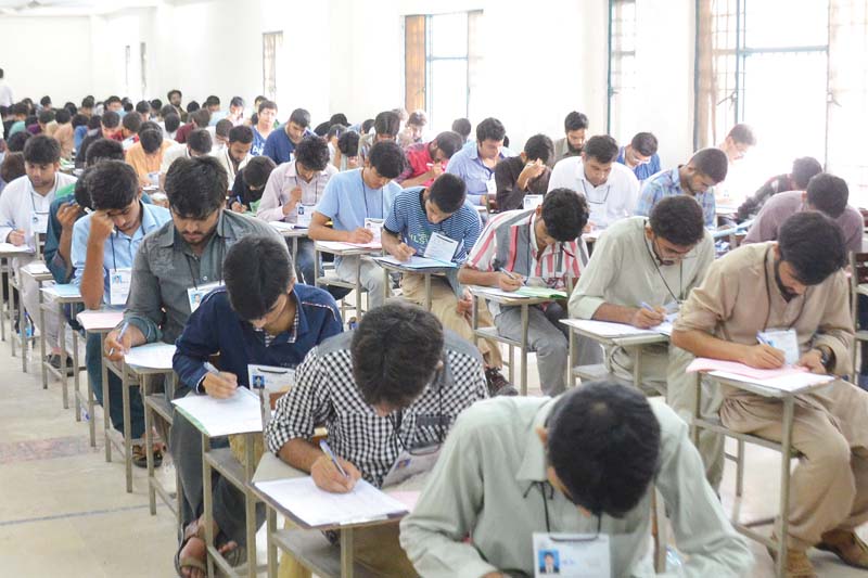 students are seen taking the entry test for admission to medical colleges at a centre on lawrence road on sunday photo shafiq malik express