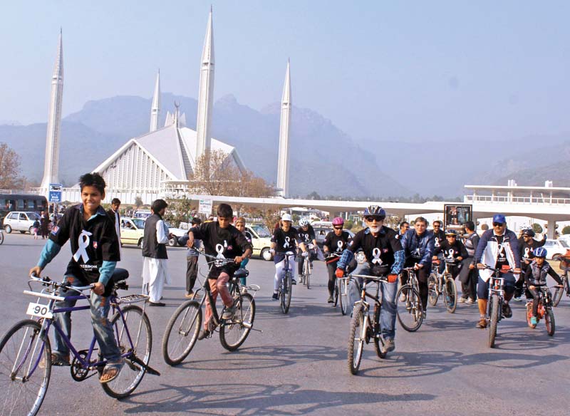 people take part in white ribbon cycle rally held to create awareness about violence against women photo waseem nazir express