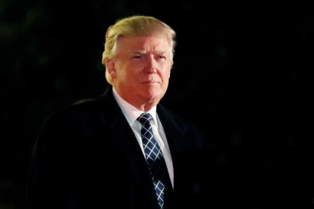 u s president elect donald trump looks towards the media as he arrives at a costume party at the home of hedge fund billionaire and campaign donor robert mercer in head of the harbor new york us december 3 2016 photo reuters