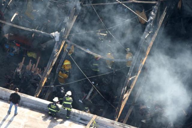 firefighters work inside the burned warehouse following the fatal fire in the fruitvale district of oakland california us december 4 2016 photo reuters