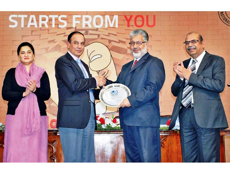 hec chairman dr mukhtar ahmed presents a shield to nab chairman qamar zaman chaudhry photo online