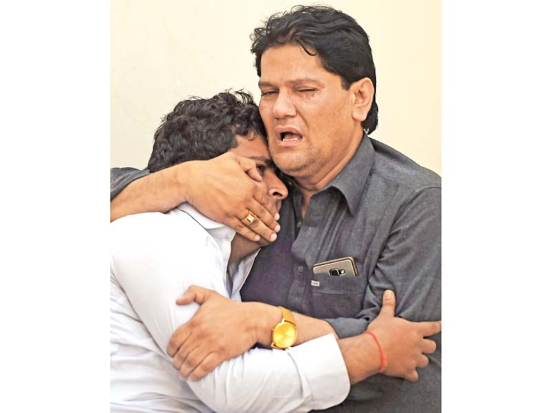 relatives mourn the death of their loved ones at a hospital following the fire at regent plaza hotel photo afp