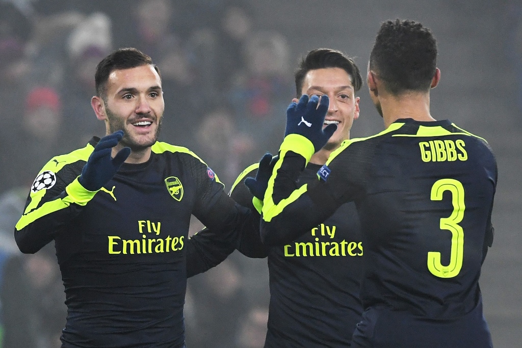 lucas perez l celebrates with mesut ozil 2r and kieran gibbs after scoring a goal on december 6 2016 at the st jakob park stadium in basel photo afp