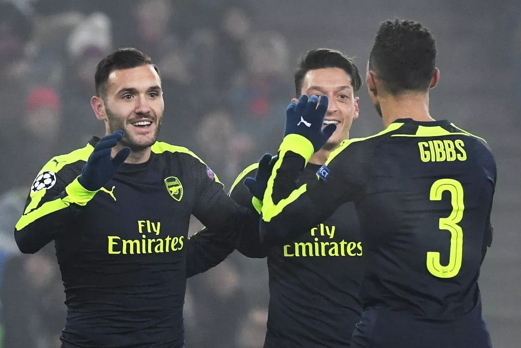lucas perez l celebrates with mesut ozil 2r and kieran gibbs after scoring a goal on december 6 2016 at the st jakob park stadium in basel photo afp lucas perez l celebrates with mesut ozil 2r and kieran gibbs after scoring a goal on december 6 2016 at the st jakob park stadium in basel photo afp