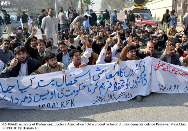 doctors stage a sit in outside the peshawar press club on wednesday to protest against kidnappings of their colleagues photo inp doctors stage a sit in outside the peshawar press club on wednesday to protest against kidnappings of their colleagues photo inp