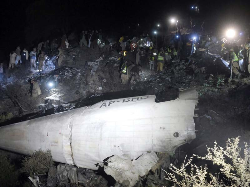 soldiers and volunteers scour the wreckage of the crashed pia plane in abbottabad district photo afp