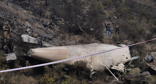 investigators scan the wreckage of the crashed pia passenger plane flight pk661 at the crash site near the village of saddha batolni in the abbottabad district of khyber pakhtunkhwa on december 8 2016 photo afp