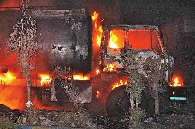 a view of the oil tanker that caught fire while offloading fuel at a fuel station on hussainabad road photo online a view of the oil tanker that caught fire while offloading fuel at a fuel station on hussainabad road photo online