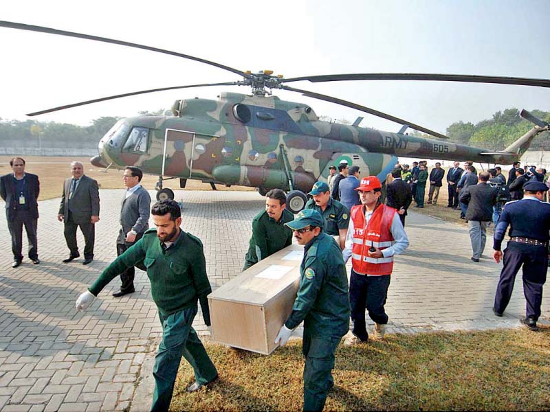 rescuers carry the remains of a crash victim brought to islamabad photo afp